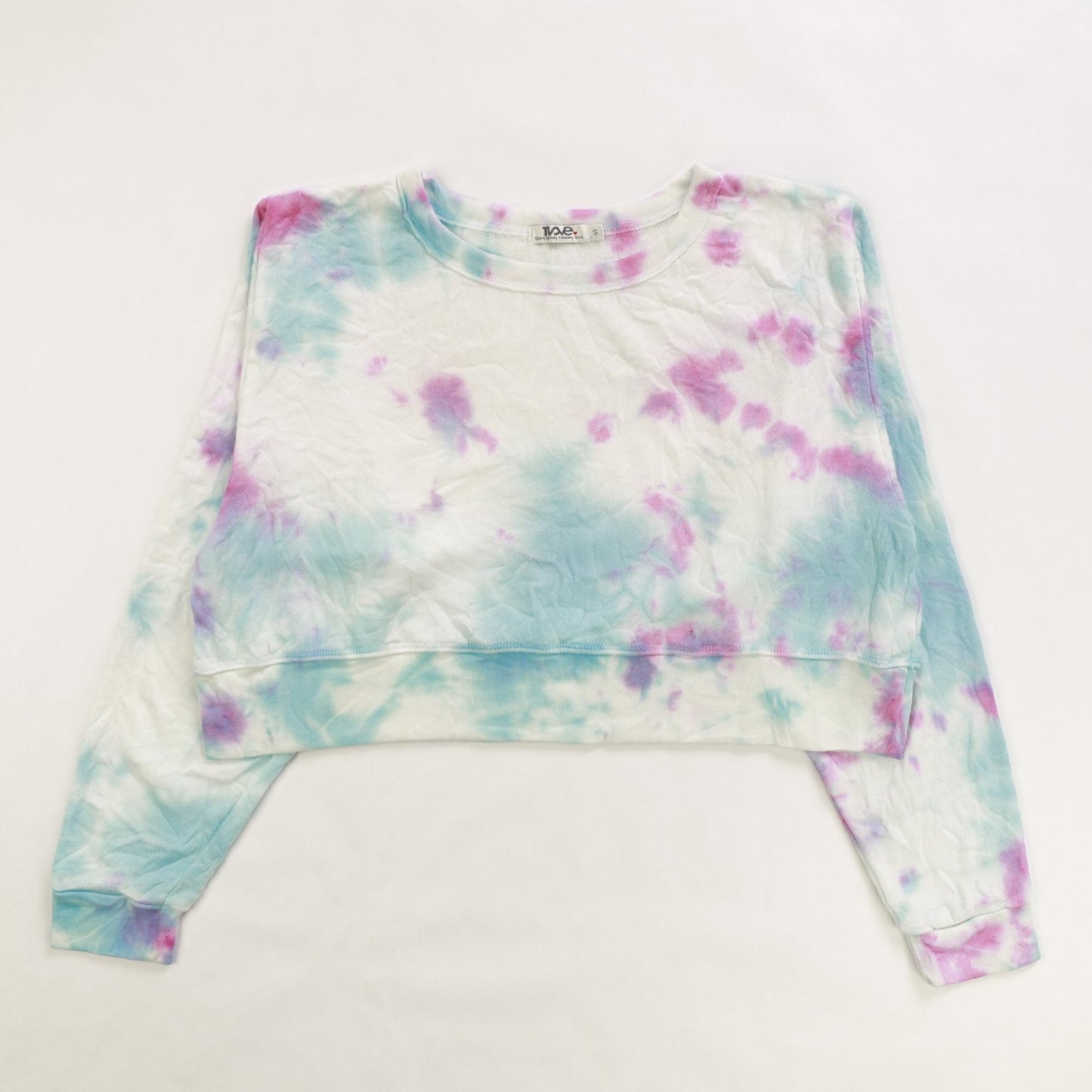 women's blue and pink tie-dye splotches on white fabric shorter-length sweater