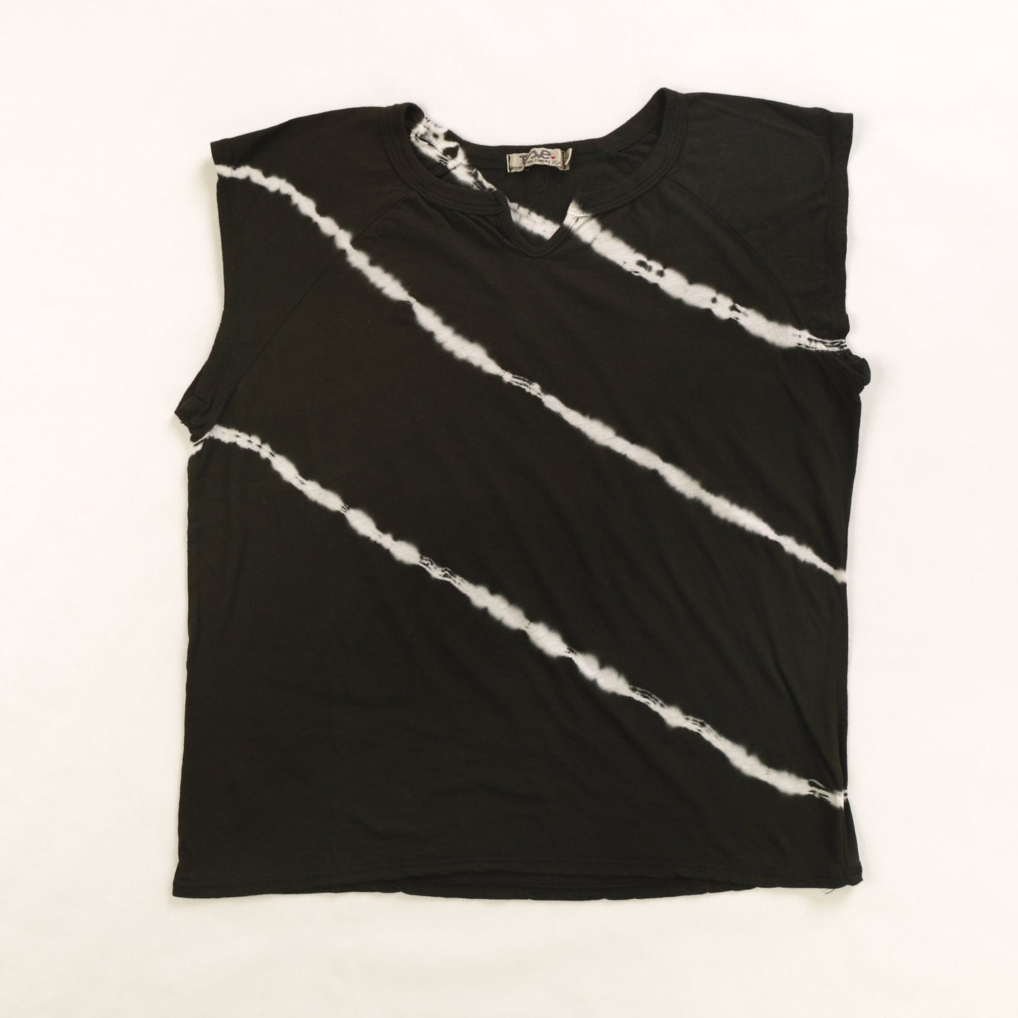 women's black tee with 3 white diagonal tie-dye lines with short torso and a v-shaped notch on the front of the neckline