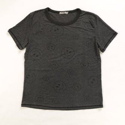 women's simple black t-shirt with larger and smaller happy faces spaced out and randomly distributed across the fabric