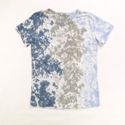 women's simple t-shirt with light blue tie-dye splatter  down the left side of the shirt, gray tie-dye splatter down the middle of the shirt, and navy blue tie-dye splatter down the right side of the shirt