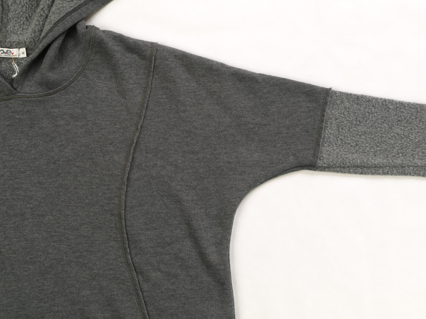 close-up of women's wide gray hoodie with reversed-fabric long-sleeves