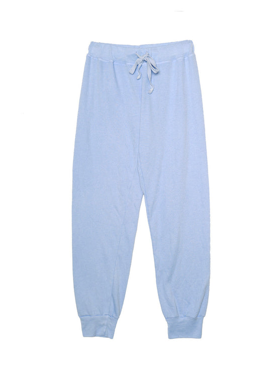 women's light blue sweatpants with elastic cuffs at the ends of the pant legs and drawstring tied into a bow at the front of the waistband